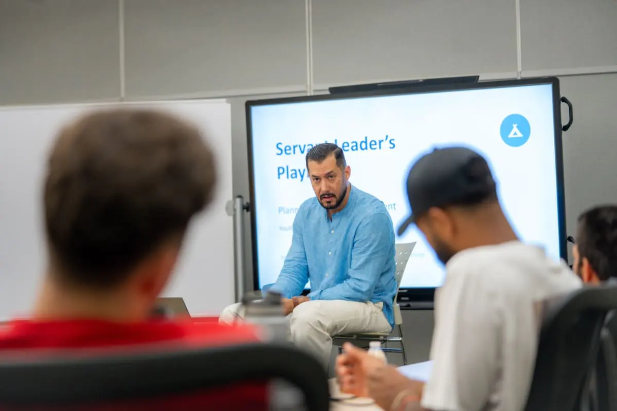 A speaker leading a discussion with young men at the first MAS retreat