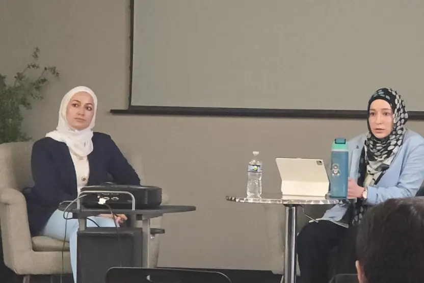 Two women speakers sharing their experience at a MAS community event